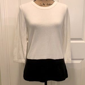 Stylish white and black top with detail trim.